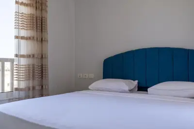 a large bed with a blue headboard in a bedroom at Exquisite 2 Bdr Apartment Waterside in Hurghada