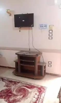 a living room with a flat screen tv on a wall at elqusier redsea in Quseir