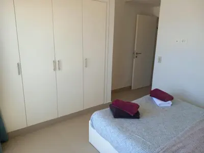 a bedroom with a bed and white cabinets at Blue Lagoon View - 2 Bed 2 Bath - Shared Pool - El Gouna in Hurghada