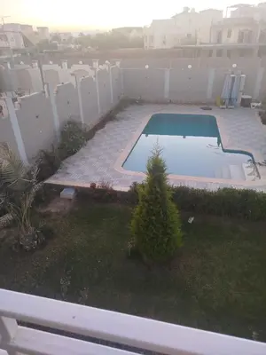 a view of a backyard with a swimming pool at Flat in villa San George in Hurghada