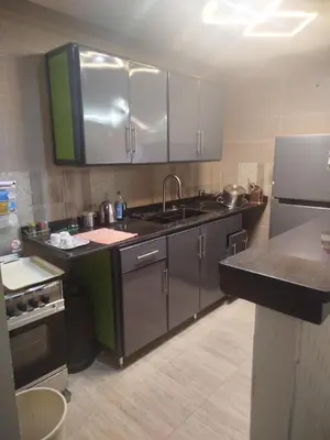 a kitchen with a sink and a refrigerator at Flat in villa San George in Hurghada