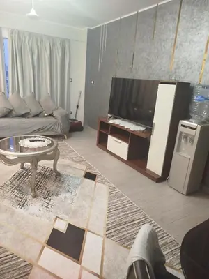 a living room with a couch and a tv at Flat in villa San George in Hurghada