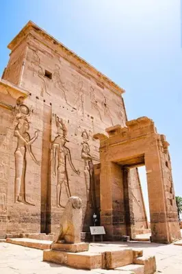 a building with a statue in front of it at Isis Nubian Services in Jazīrat Aswān