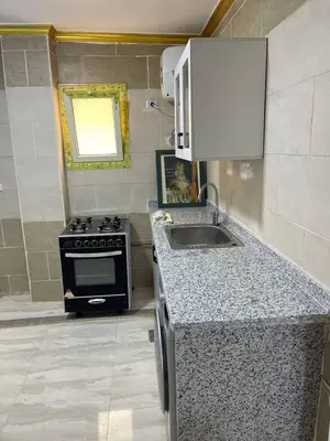 a kitchen with a stove and a sink at Aven Resort Compound in Hurghada