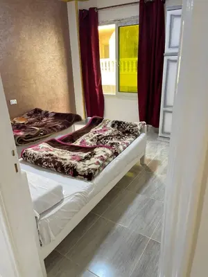 a bedroom with two beds in a room at Aven Resort Compound in Hurghada