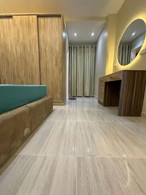 a living room with a couch and a mirror at 2 Bedroom in Al Hambra - Mamsha in Hurghada