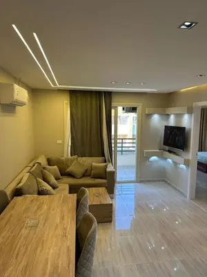 a living room with a couch and a table at 2 Bedroom in Al Hambra - Mamsha in Hurghada