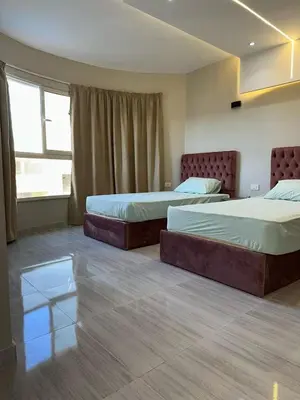 a bedroom with two beds and a window at 2 Bedroom in Al Hambra - Mamsha in Hurghada