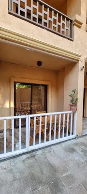 a house with a white fence and a balcony at Turtles Beach Resort- Hurghada in Hurghada