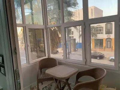 a room with a window with chairs and a table at 2 Bedroom in Andreas Residence in Hurghada