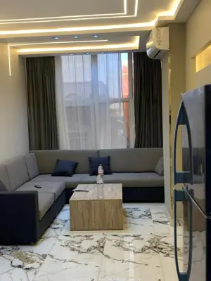 a living room with a couch and a coffee table at 2 Bedroom in Andreas Residence in Hurghada