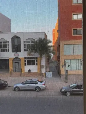 two cars parked in a parking lot in front of buildings at 2 Bedroom in Andreas Residence in Hurghada