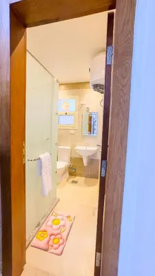 a bathroom with a glass shower and a sink at Elite AlDaU Heights in Hurghada