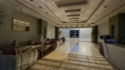 a living room with couches and chairs in a lobby at Elite AlDaU Heights in Hurghada