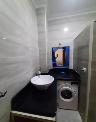 a bathroom with a sink and a washing machine at الغردقة in Hurghada