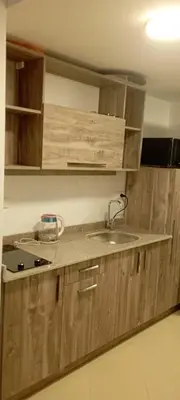 a kitchen with wooden cabinets and a sink at Compound floranza in Hurghada