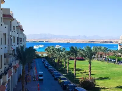 a view of a street with palm trees and water at Sea view Luxury apartment at Al Andalous Sahl Hasheesh in Hurghada