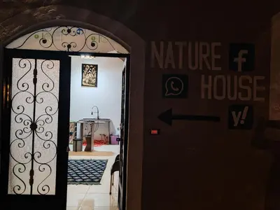 an entrance to a house with a door with a sign at Nature House in Luxor