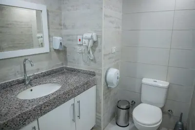 a bathroom with a sink and a toilet and a mirror at Hurghada Scandic in Hurghada