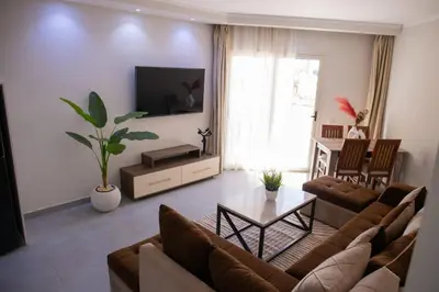 a living room with a couch and a table at Hurghada Scandic in Hurghada