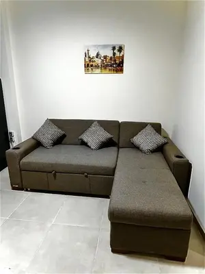 a brown couch in a living room at Hurghada Holiday Studio with Beach in Hurghada