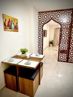 a dining room with a table and an arched doorway at Hurghada Holiday Studio with Beach in Hurghada