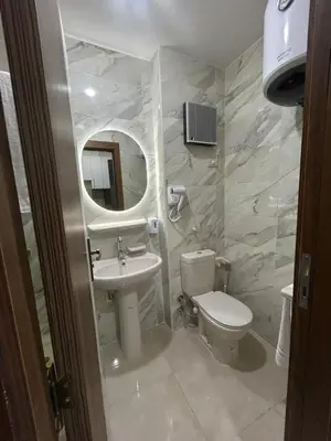 a bathroom with a toilet and a sink and a mirror at Hurghada Holiday Studio with Beach in Hurghada