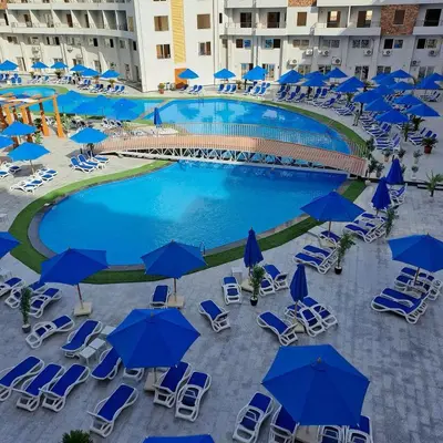 an overhead view of a pool with chairs and umbrellas at Hurghada Holiday Studio with Beach in Hurghada