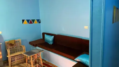 a living room with a couch and a table at AnDy Nubian Guest House in Aswan