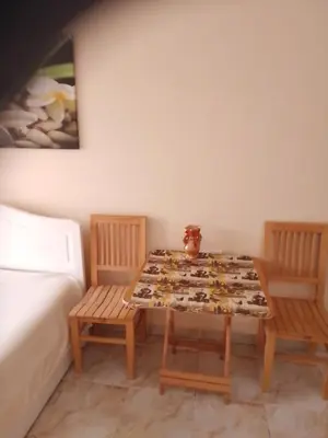 a table and two chairs in a room at Studio on the roof in Hurghada