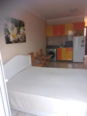 a kitchen with a white bed in a room at Studio on the roof in Hurghada
