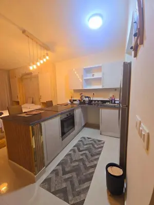 a small kitchen with a counter and a refrigerator at Veranda sahl hasheesh in Hurghada