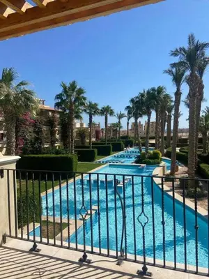 a view of a swimming pool with palm trees at Veranda sahl hasheesh in Hurghada