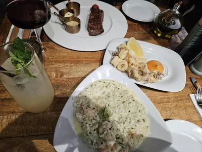 a table with three plates of food and a drink at Angel in Hurghada