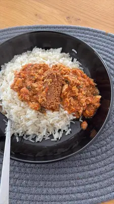 a plate of rice and meat on a table at Angel in Hurghada