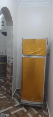 a yellow refrigerator in a room with a hallway at Sphinx Avenue street in Luxor