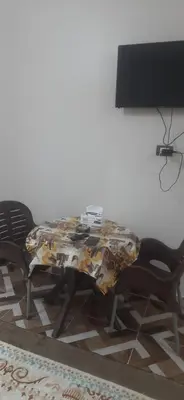 a table and two chairs with a patterned table at Sphinx Avenue street in Luxor