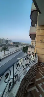 a balcony of a building with a view of a street at Sphinx Avenue street in Luxor