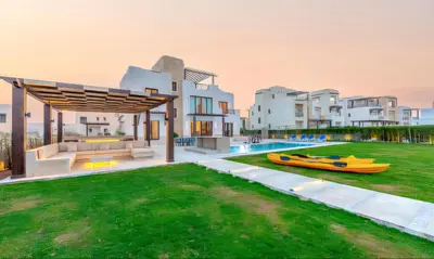 an image of a house with a boat in the yard at Luxury Stays in Ancient Sands El Gouna in Hurghada