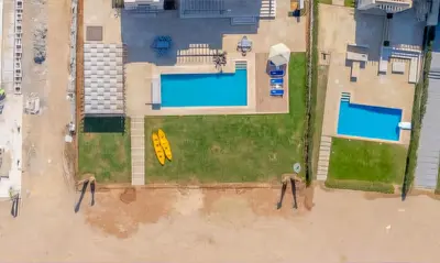an overhead view of two swimming pools in a yard at Luxury Stays in Ancient Sands El Gouna in Hurghada