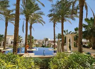 a resort with a pool and palm trees at Luxury Stays in Ancient Sands El Gouna in Hurghada