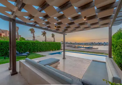 a patio with a couch under a pergola at Luxury Stays in Ancient Sands El Gouna in Hurghada