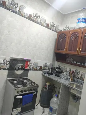 a kitchen with a stove and a sink at Fully furnished studio with all services and amenities close to the beach in Hurghada