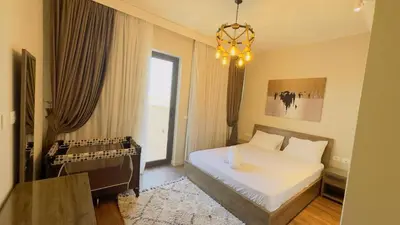 a bedroom with a large bed and a chandelier at Luxury villa in gouna in Hurghada