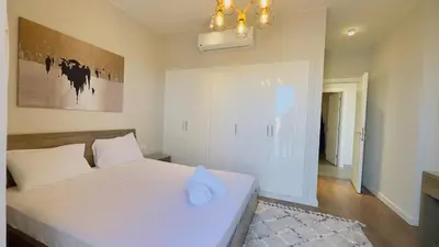 a bedroom with a white bed with a blue towel on it at Luxury villa in gouna in Hurghada