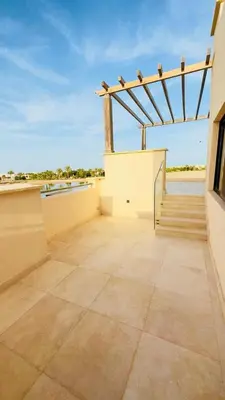 a balcony of a building with a wooden structure at Luxury villa in gouna in Hurghada