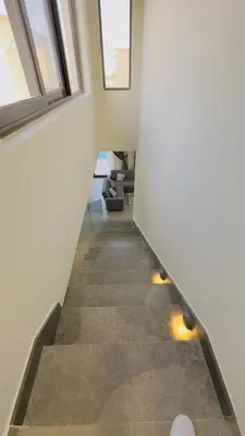 a hallway with a staircase with lights on the floor at Luxury villa in gouna in Hurghada
