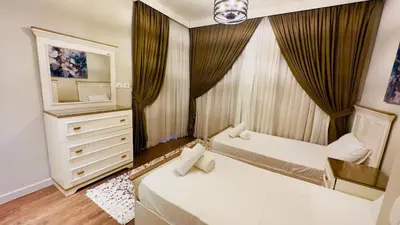 a bedroom with two beds and a dresser with a mirror at Luxury villa in gouna in Hurghada