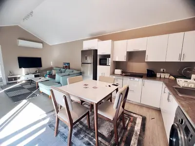 a kitchen and living room with a table and chairs at Bali A 22 in Hurghada
