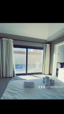 a bedroom with a bed and a large window at Bali A 22 in Hurghada